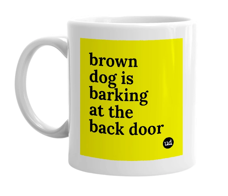 White mug with 'brown dog is barking at the back door' in bold black letters