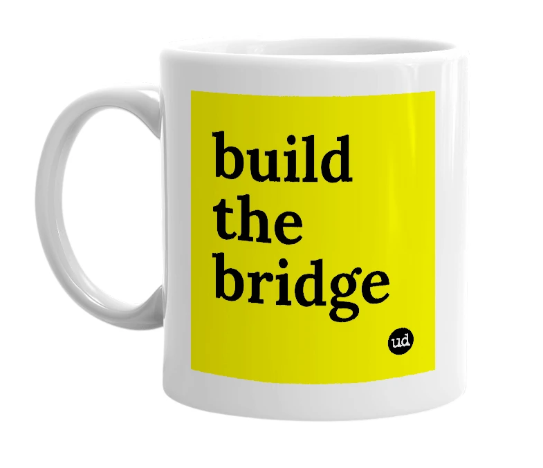 White mug with 'build the bridge' in bold black letters