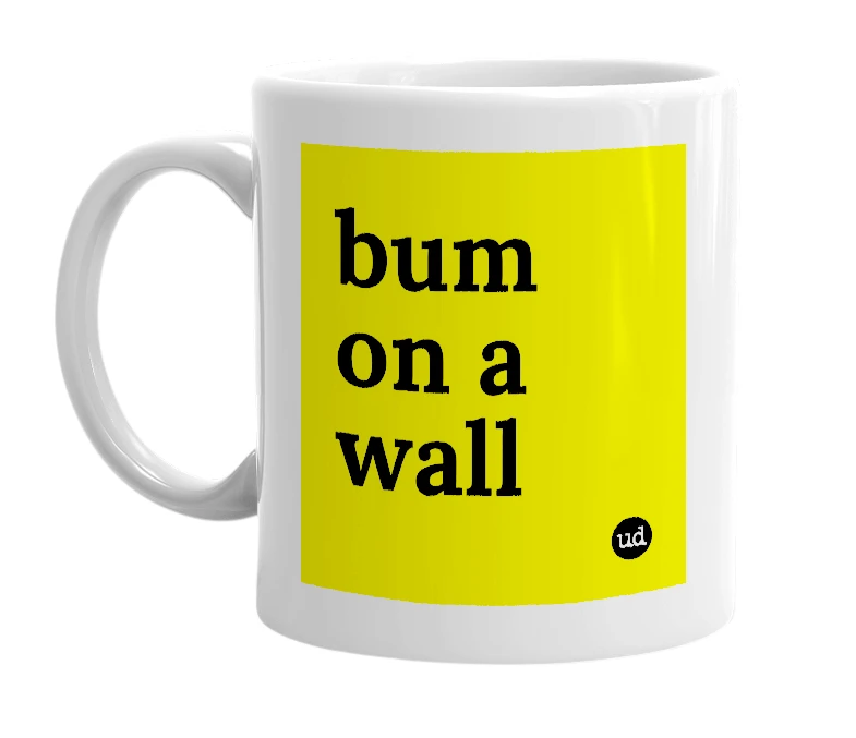 White mug with 'bum on a wall' in bold black letters