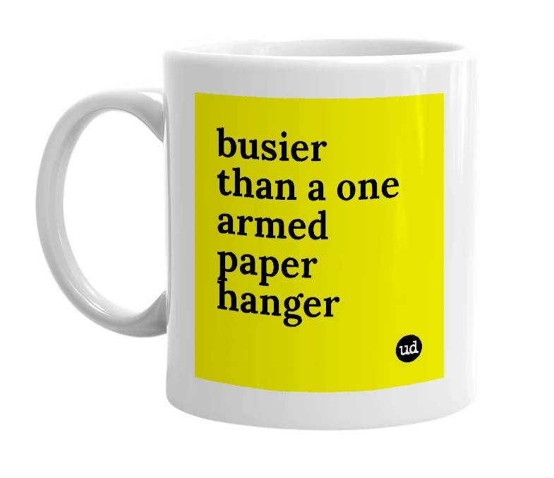 White mug with 'busier than a one armed paper hanger' in bold black letters