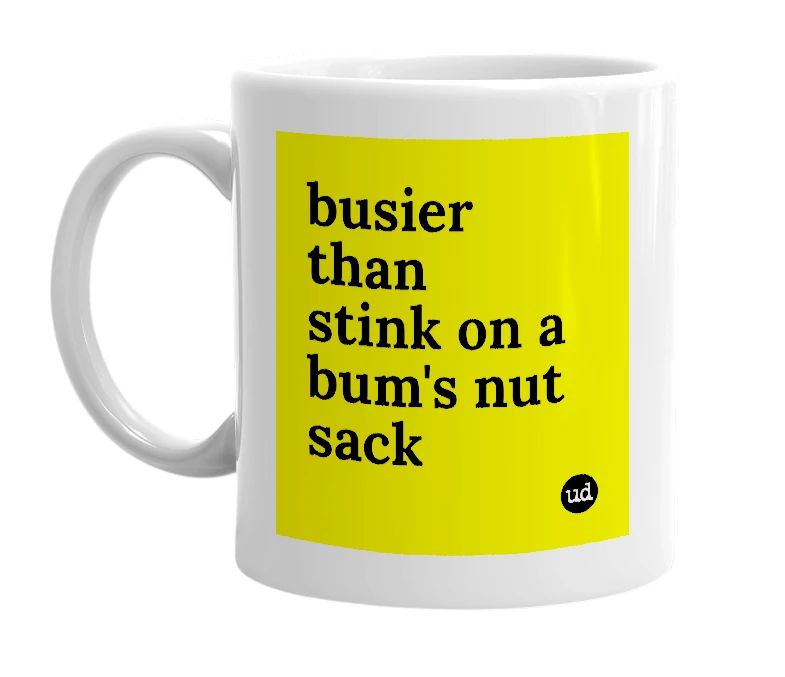 White mug with 'busier than stink on a bum's nut sack' in bold black letters