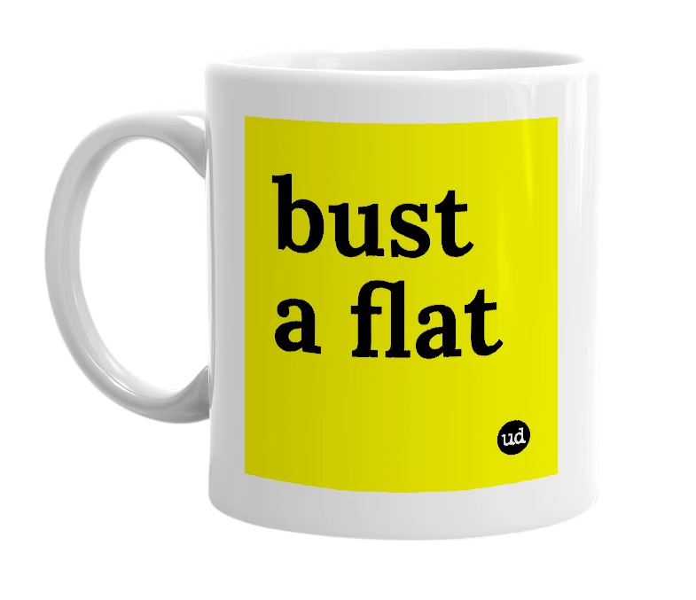 White mug with 'bust a flat' in bold black letters