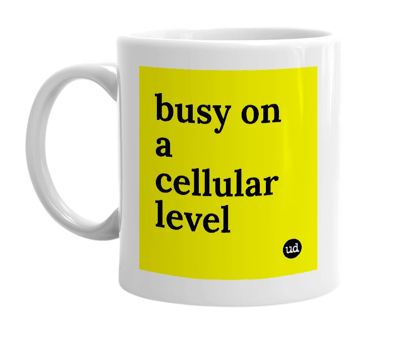 White mug with 'busy on a cellular level' in bold black letters