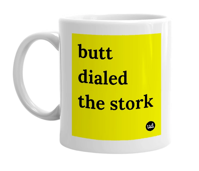 White mug with 'butt dialed the stork' in bold black letters