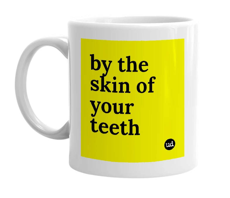 White mug with 'by the skin of your teeth' in bold black letters