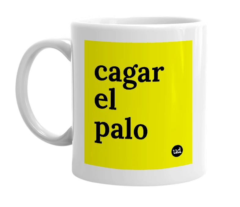 White mug with 'cagar el palo' in bold black letters