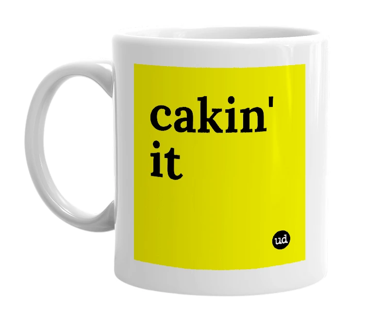 White mug with 'cakin' it' in bold black letters