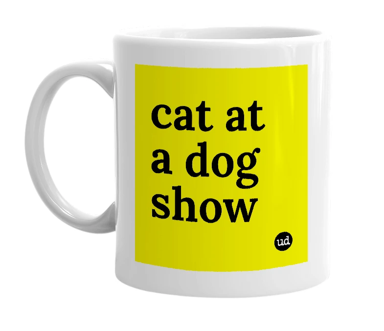 White mug with 'cat at a dog show' in bold black letters