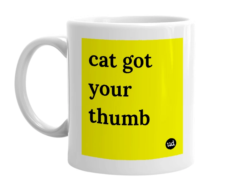 White mug with 'cat got your thumb' in bold black letters