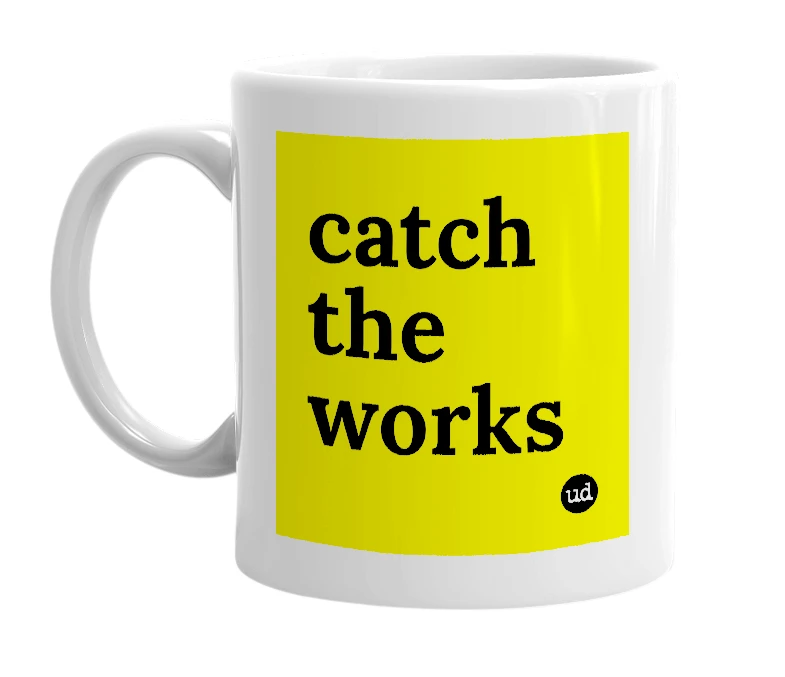 White mug with 'catch the works' in bold black letters