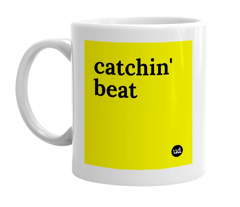 White mug with 'catchin' beat' in bold black letters