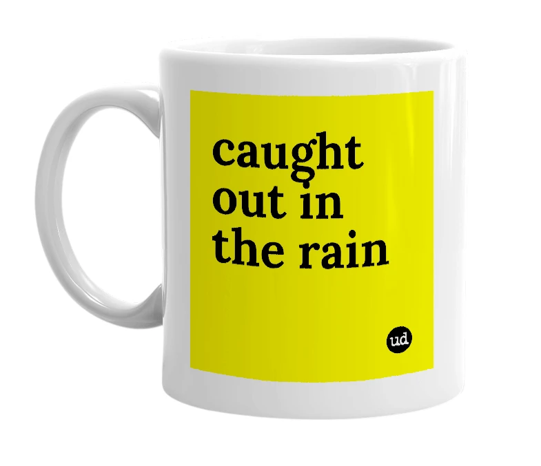 White mug with 'caught out in the rain' in bold black letters