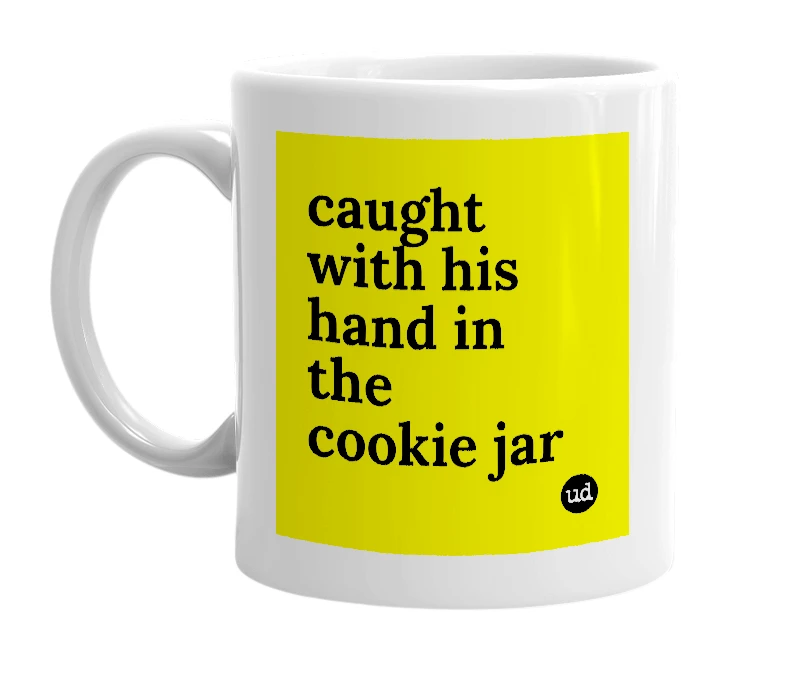 White mug with 'caught with his hand in the cookie jar' in bold black letters