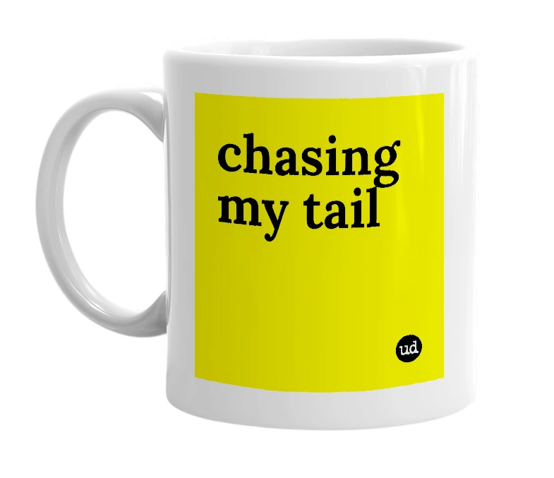 White mug with 'chasing my tail' in bold black letters