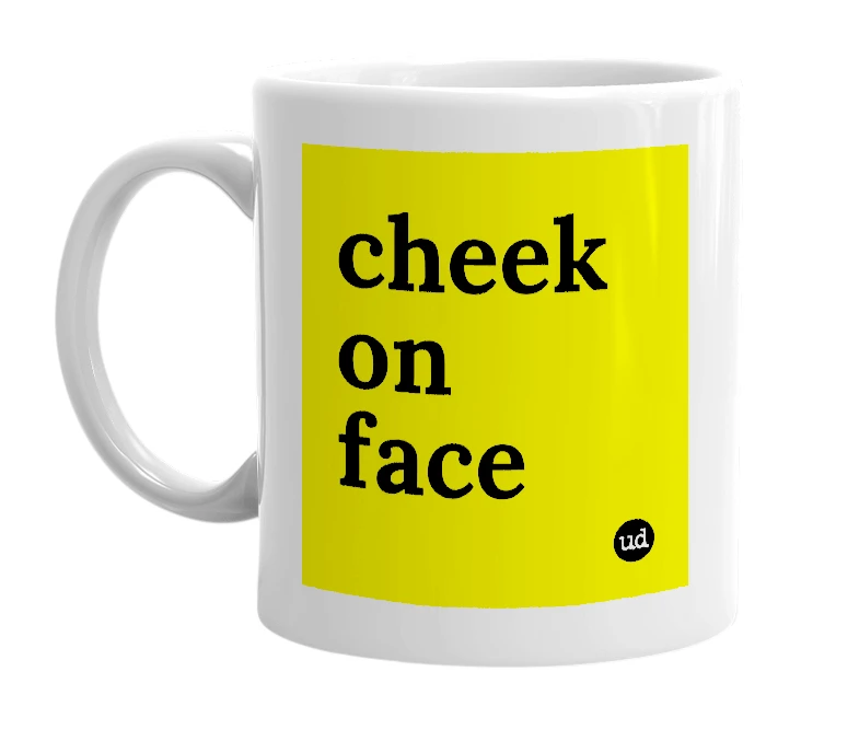 White mug with 'cheek on face' in bold black letters