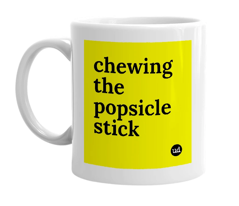 White mug with 'chewing the popsicle stick' in bold black letters