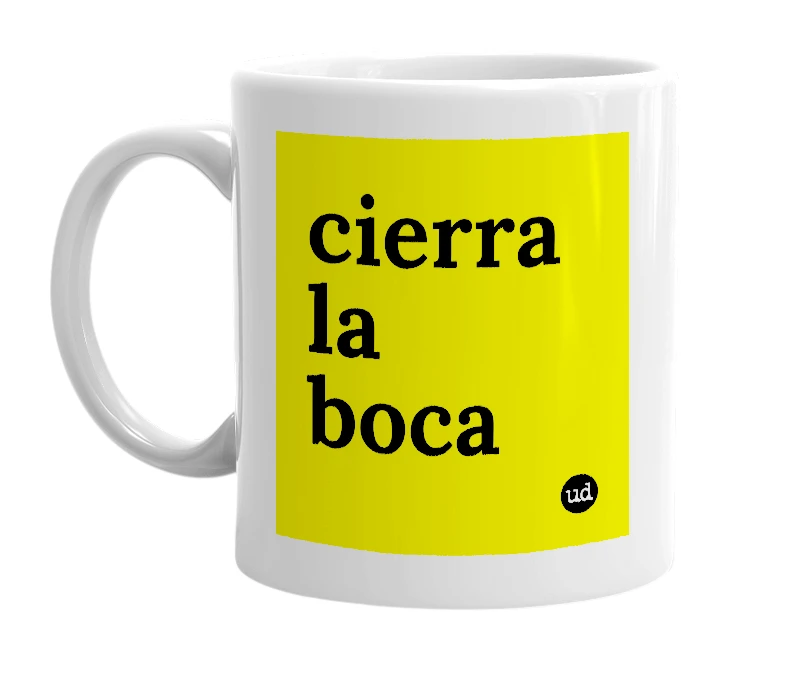 White mug with 'cierra la boca' in bold black letters