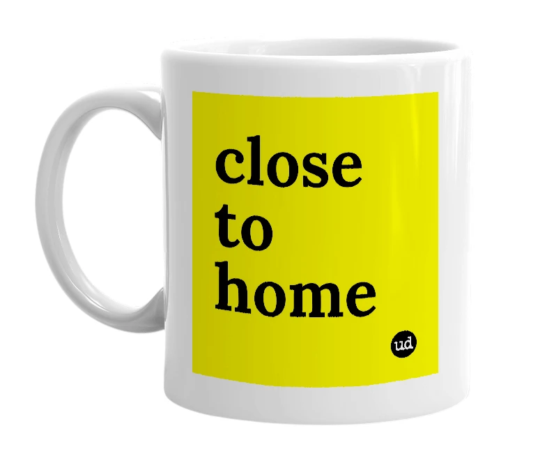 White mug with 'close to home' in bold black letters