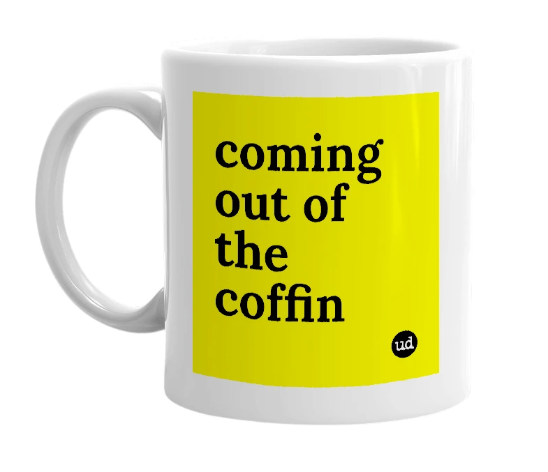 White mug with 'coming out of the coffin' in bold black letters