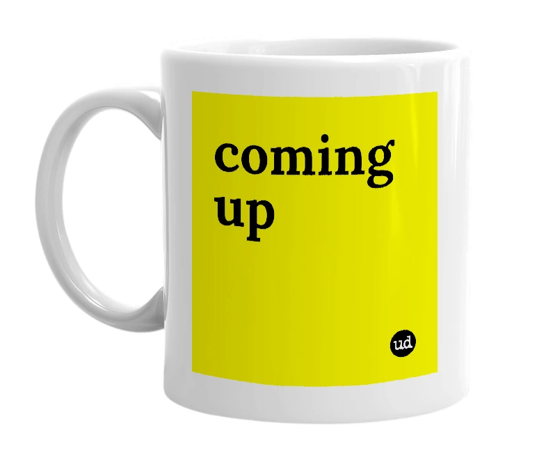 White mug with 'coming up' in bold black letters