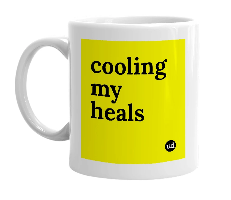White mug with 'cooling my heals' in bold black letters