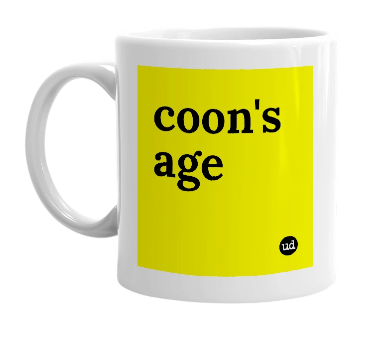 White mug with 'coon's age' in bold black letters