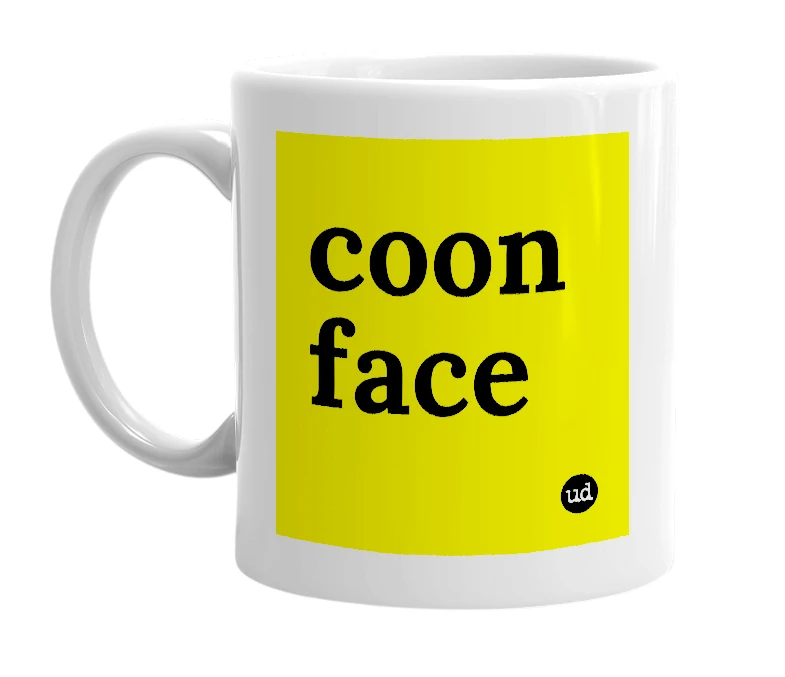 White mug with 'coon face' in bold black letters