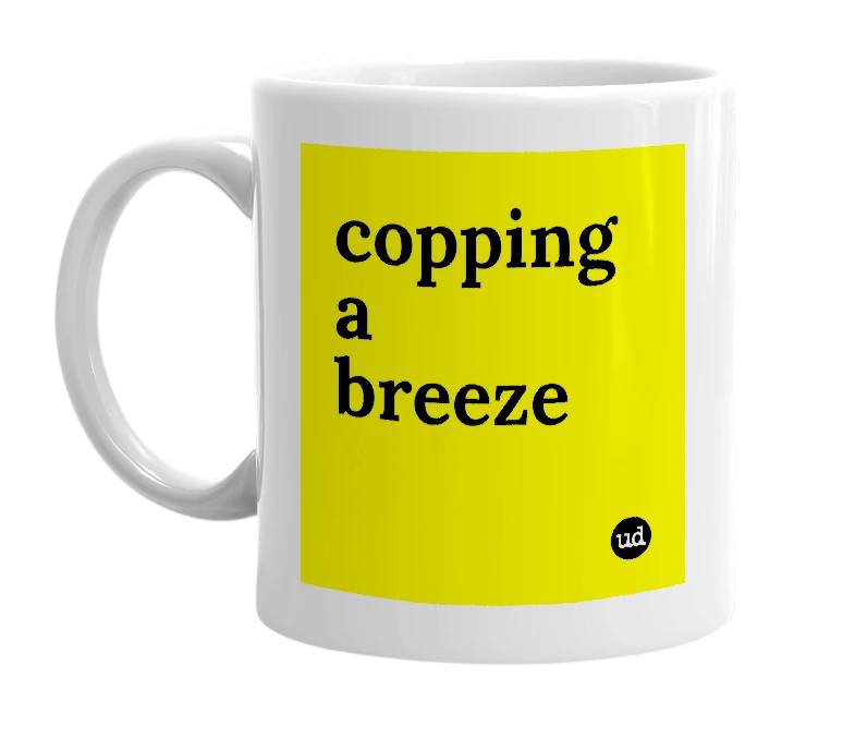 White mug with 'copping a breeze' in bold black letters