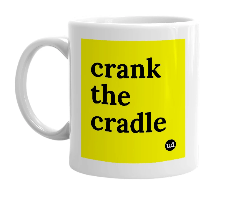 White mug with 'crank the cradle' in bold black letters