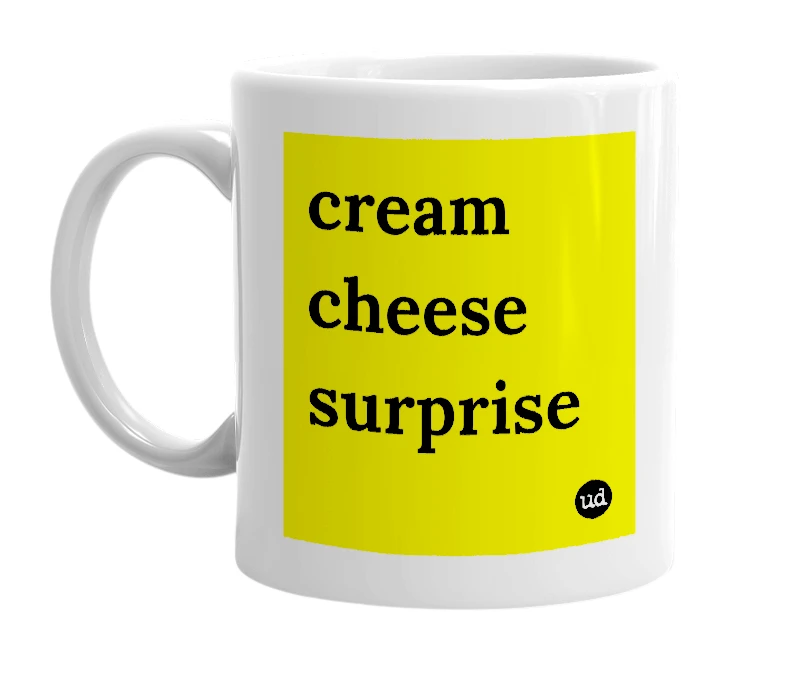 White mug with 'cream cheese surprise' in bold black letters