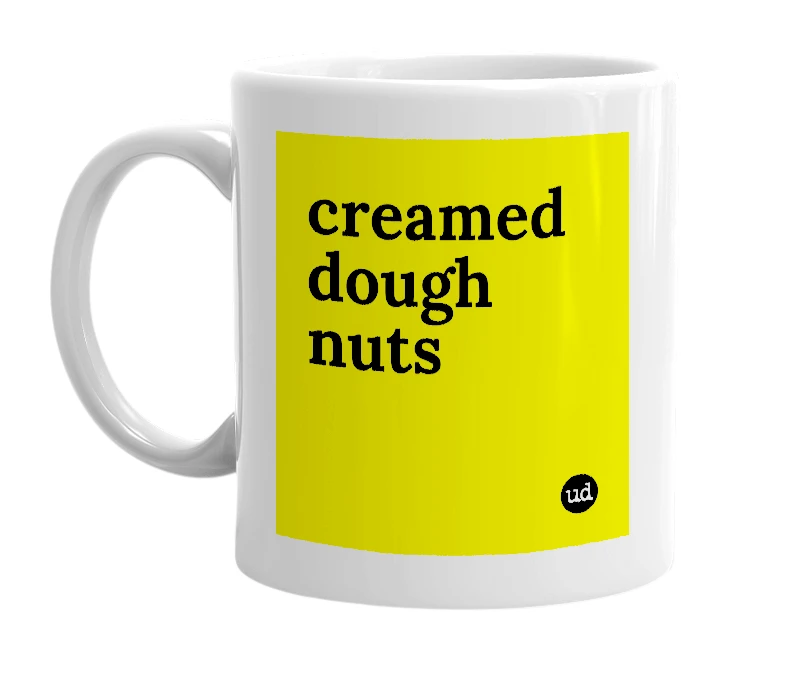 White mug with 'creamed dough nuts' in bold black letters