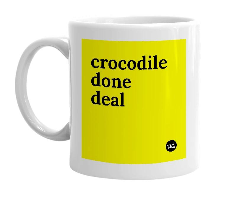 White mug with 'crocodile done deal' in bold black letters