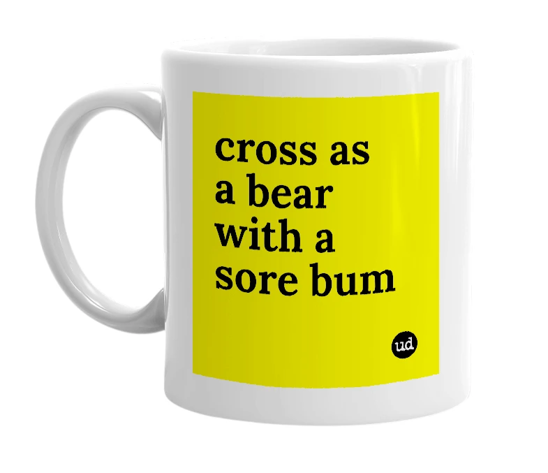 White mug with 'cross as a bear with a sore bum' in bold black letters