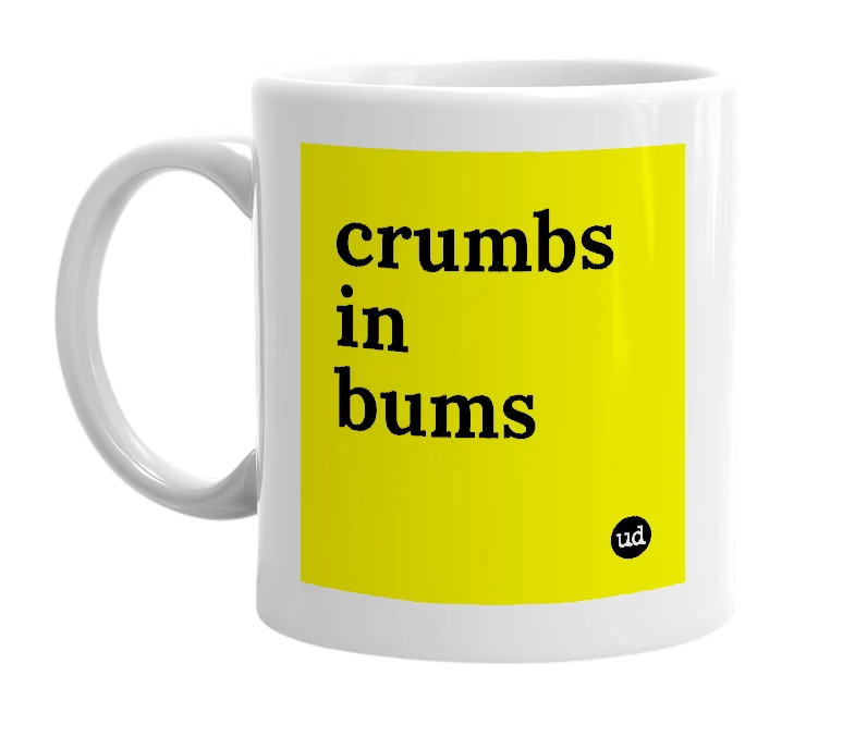 White mug with 'crumbs in bums' in bold black letters