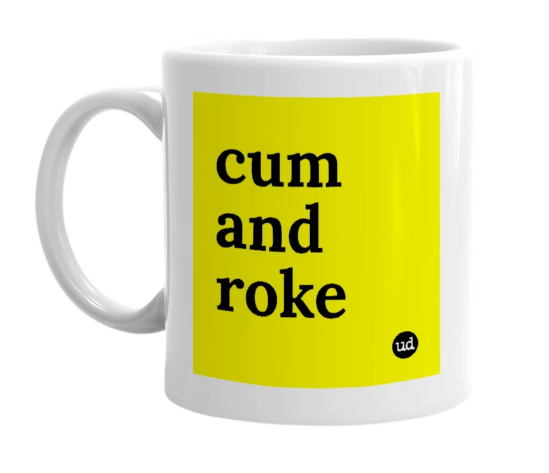 White mug with 'cum and roke' in bold black letters