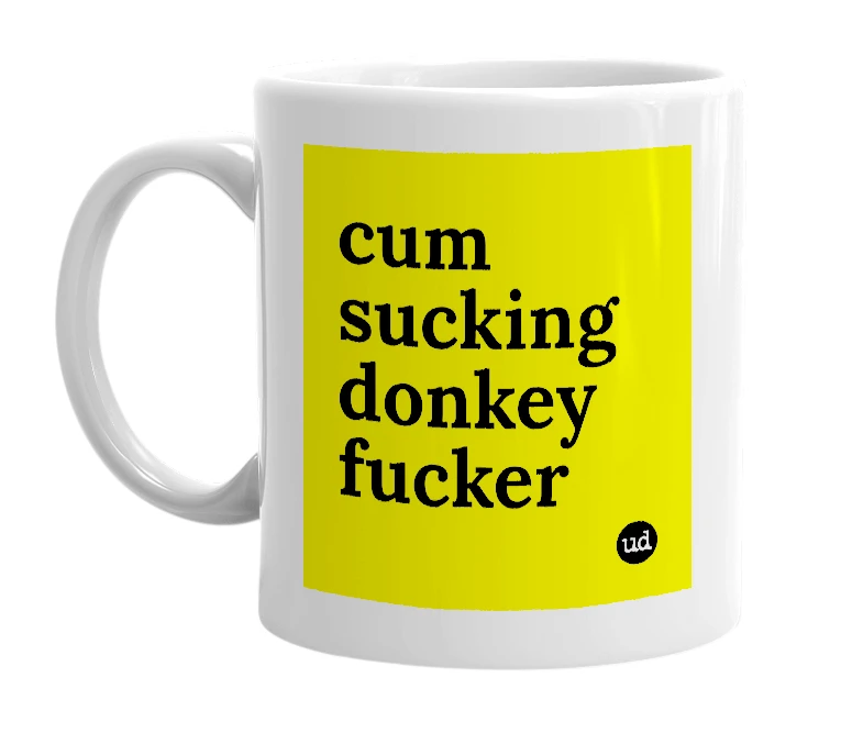 White mug with 'cum sucking donkey fucker' in bold black letters