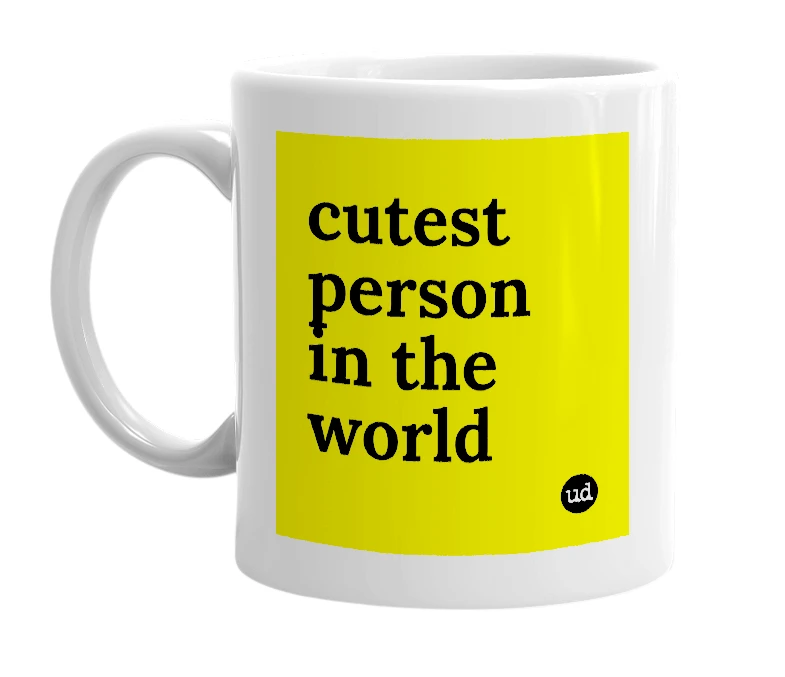 White mug with 'cutest person in the world' in bold black letters