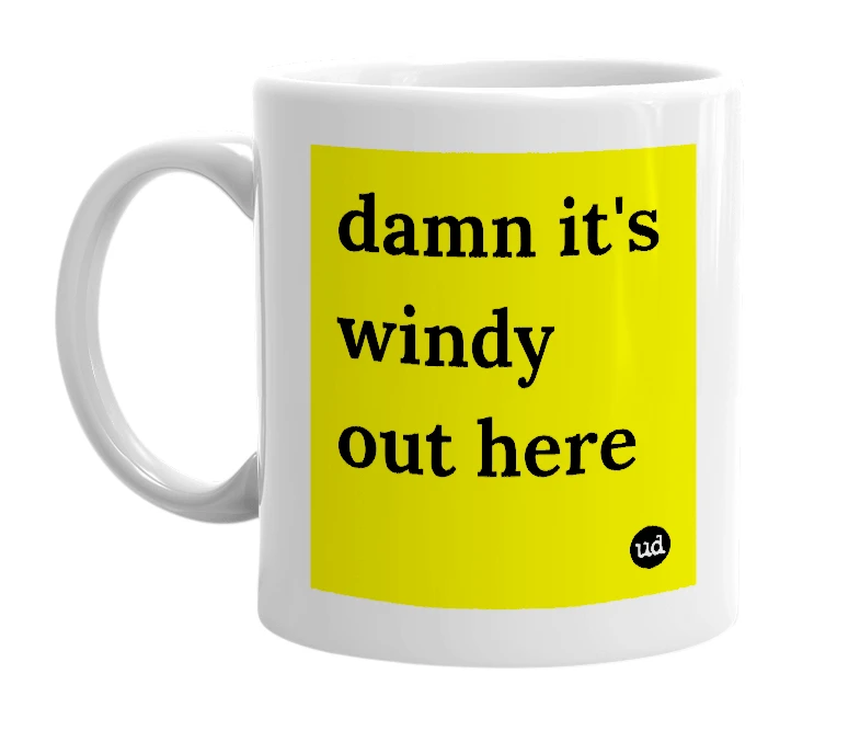 White mug with 'damn it's windy out here' in bold black letters