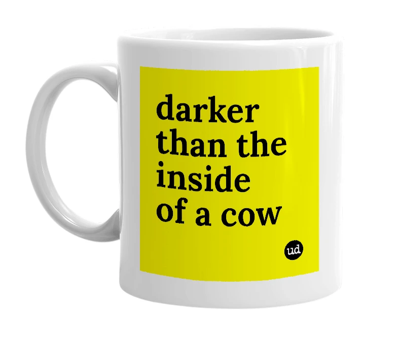 White mug with 'darker than the inside of a cow' in bold black letters