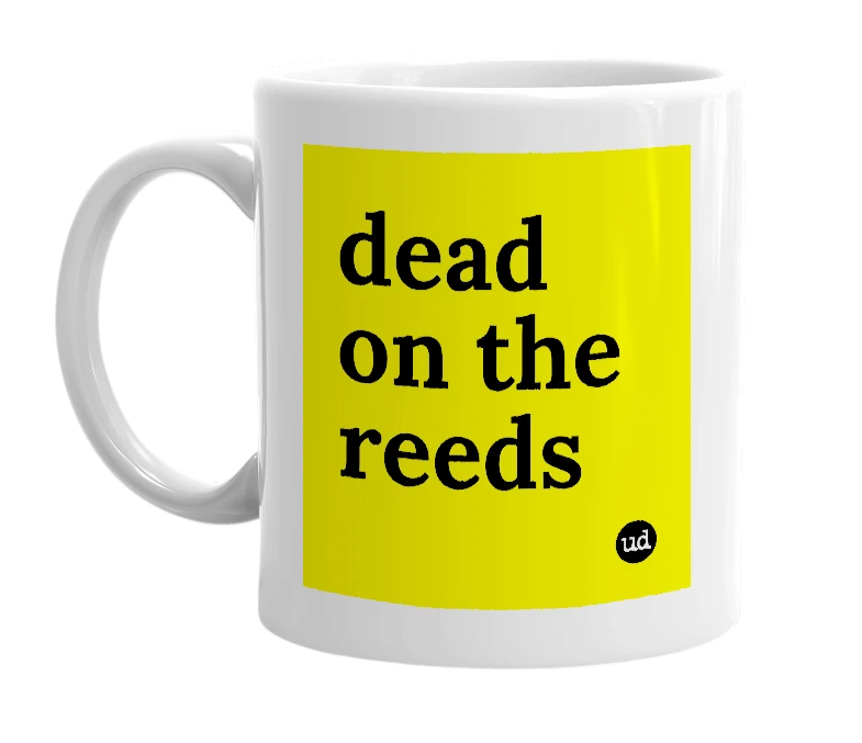 White mug with 'dead on the reeds' in bold black letters