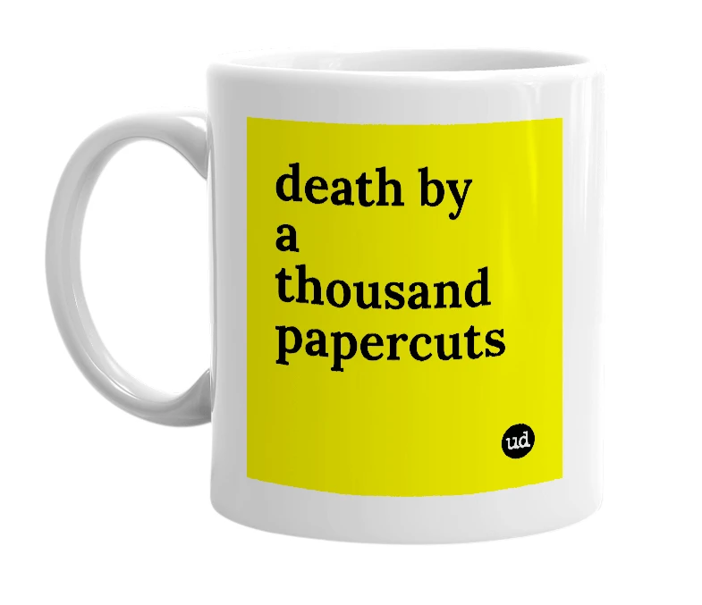White mug with 'death by a thousand papercuts' in bold black letters