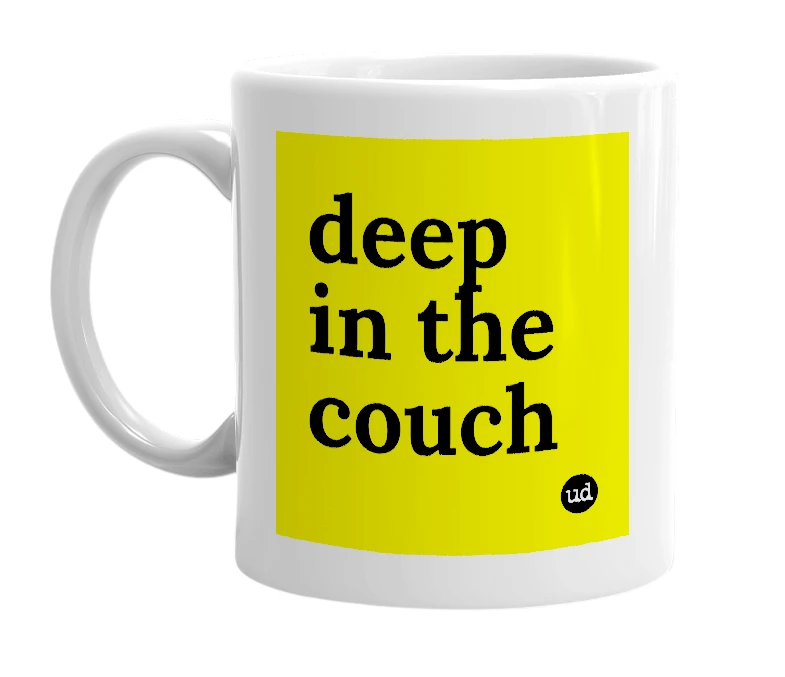 White mug with 'deep in the couch' in bold black letters