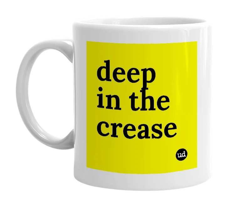 White mug with 'deep in the crease' in bold black letters