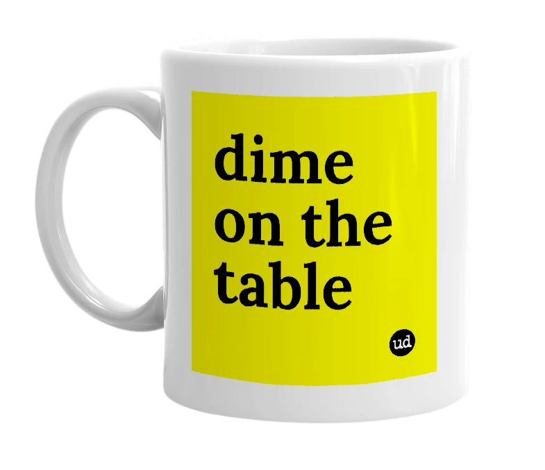 White mug with 'dime on the table' in bold black letters