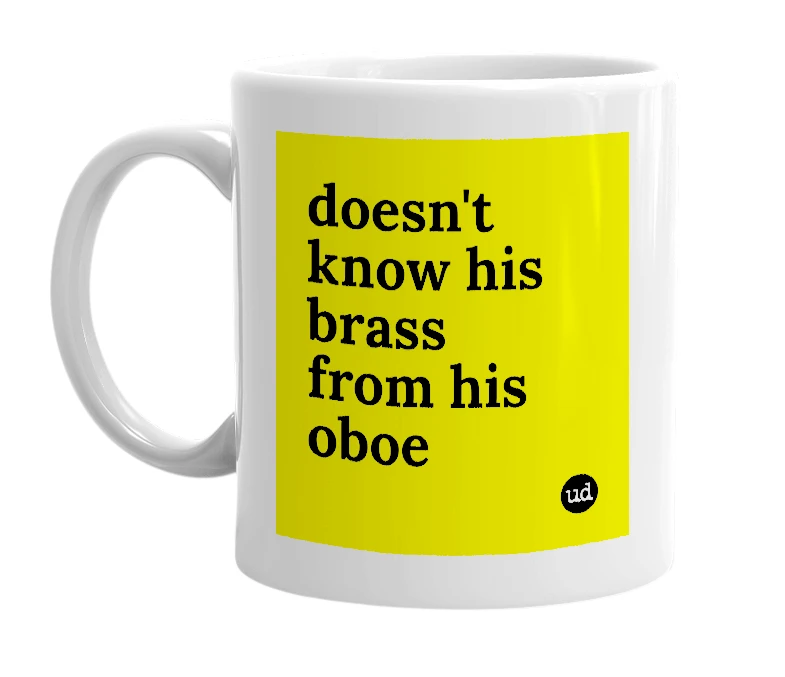 White mug with 'doesn't know his brass from his oboe' in bold black letters