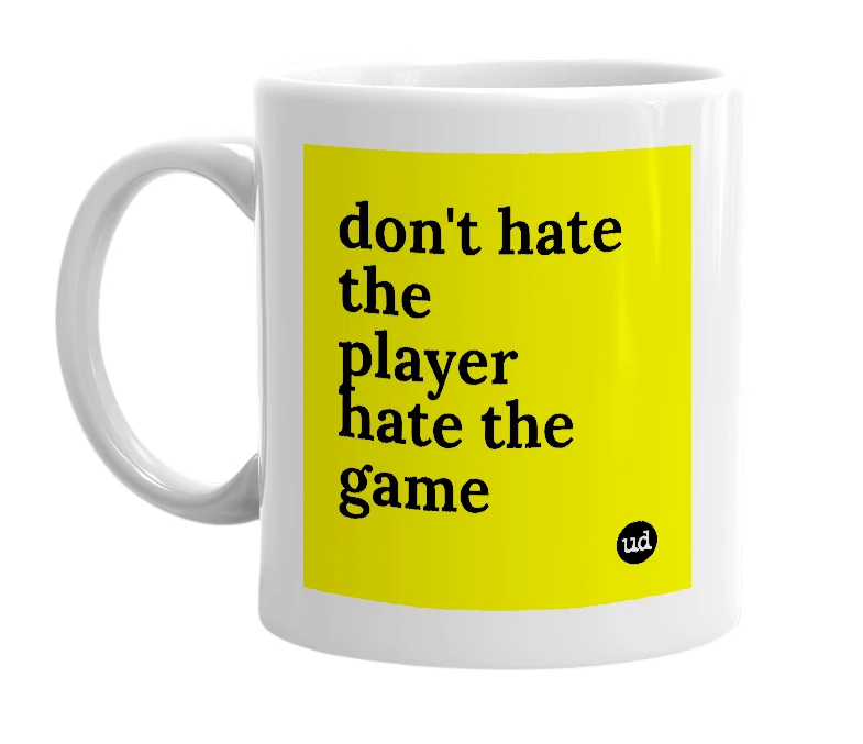 White mug with 'don't hate the player hate the game' in bold black letters