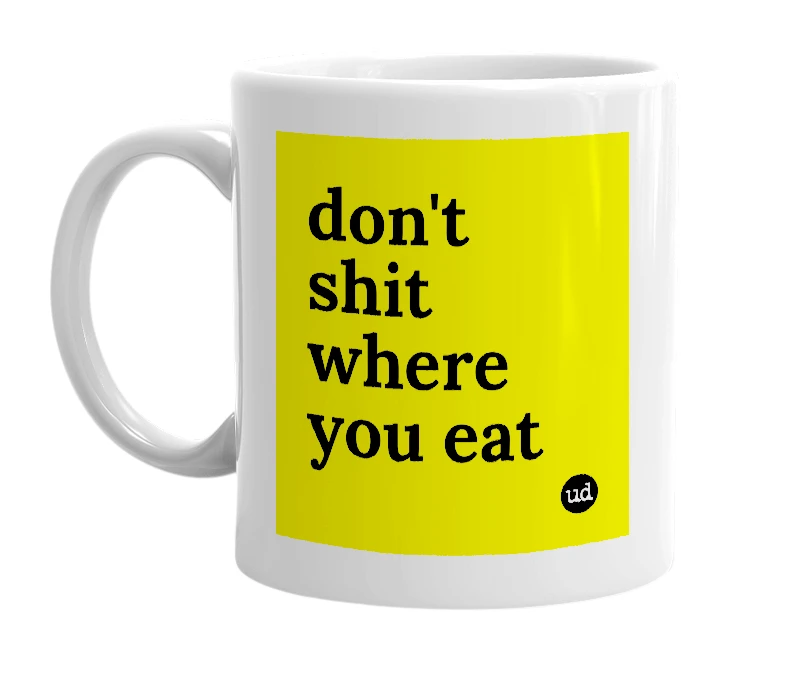 White mug with 'don't shit where you eat' in bold black letters