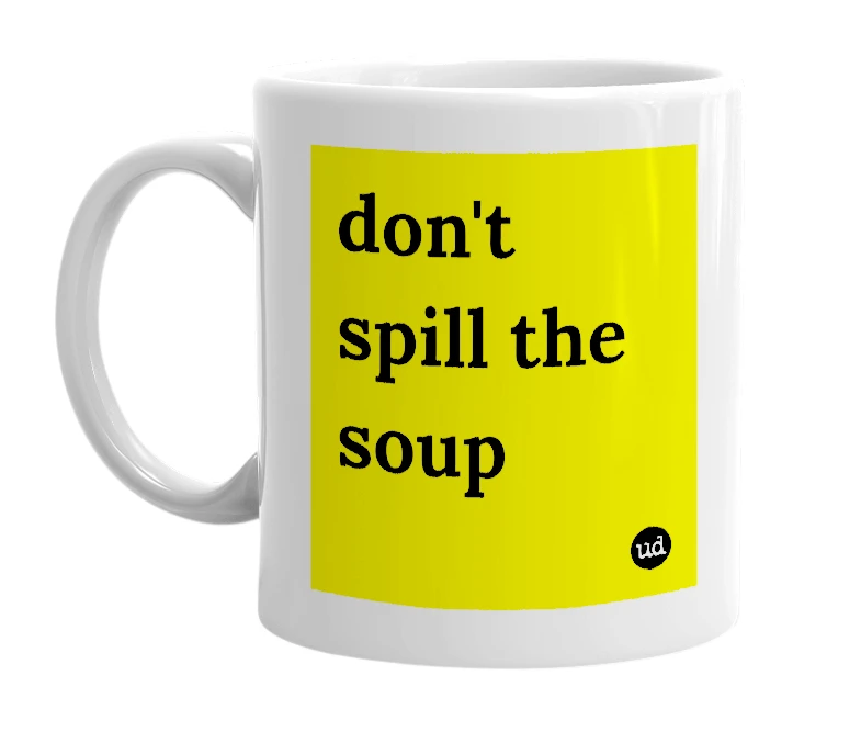 White mug with 'don't spill the soup' in bold black letters