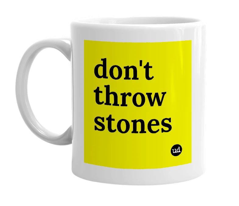 White mug with 'don't throw stones' in bold black letters