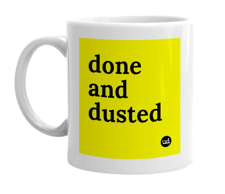 White mug with 'done and dusted' in bold black letters